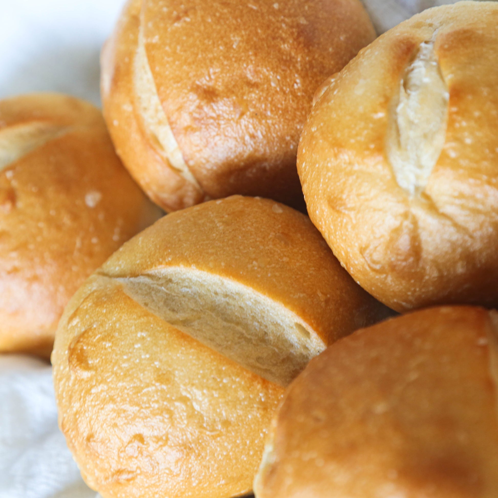 Close-up of a pile of bread rolls on a white cloth